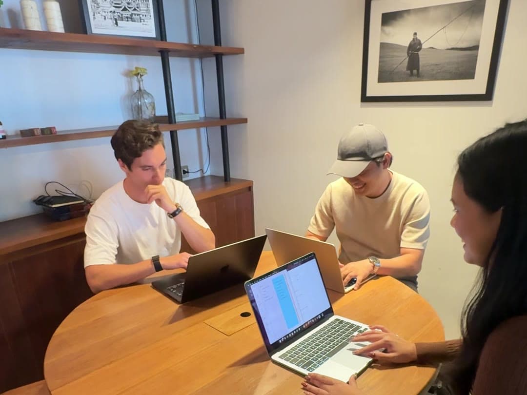 The Conlatio team working together at a table
